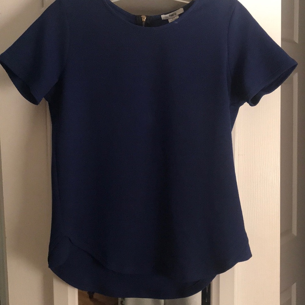 Fitted navy blue top, flares at bottom